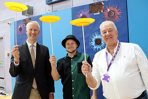 Gideon Amos MP and Cllr Rob Isaacs have a go at plate spinning with Scott Dowson from Fuse Performance and Somerset Outdoor Arts Circus Workshop. Rob Isaacs WMIS